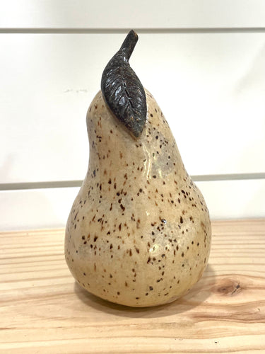 close up of a single oatmeal ceramic pear 